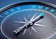 Photograph shows a compass needle pointing toward the word “future.” 