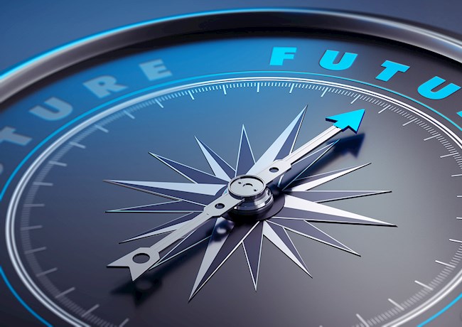 Photograph shows a compass needle pointing toward the word “future.” 
