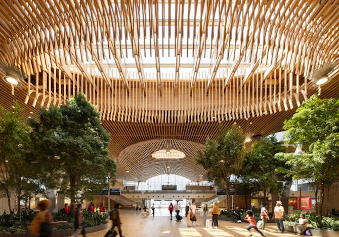 Interior view of Portland International Airport Terminal Core Redevelopment Phase One, featuring a wood‑lined ceiling and open public space.