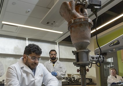 a team in a laboratory setting observes 3D printing