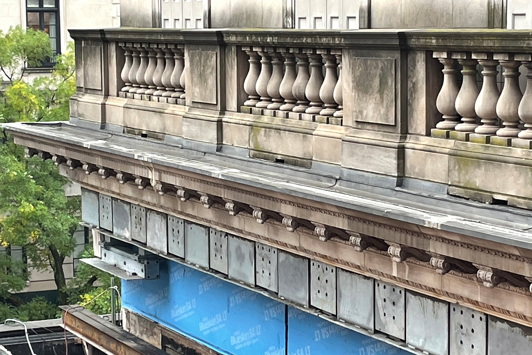 The cornices of a building are shown as are the beams to support the stone. 