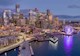 The photo shows the Seattle skyline and the new waterfront park illuminated at night. 