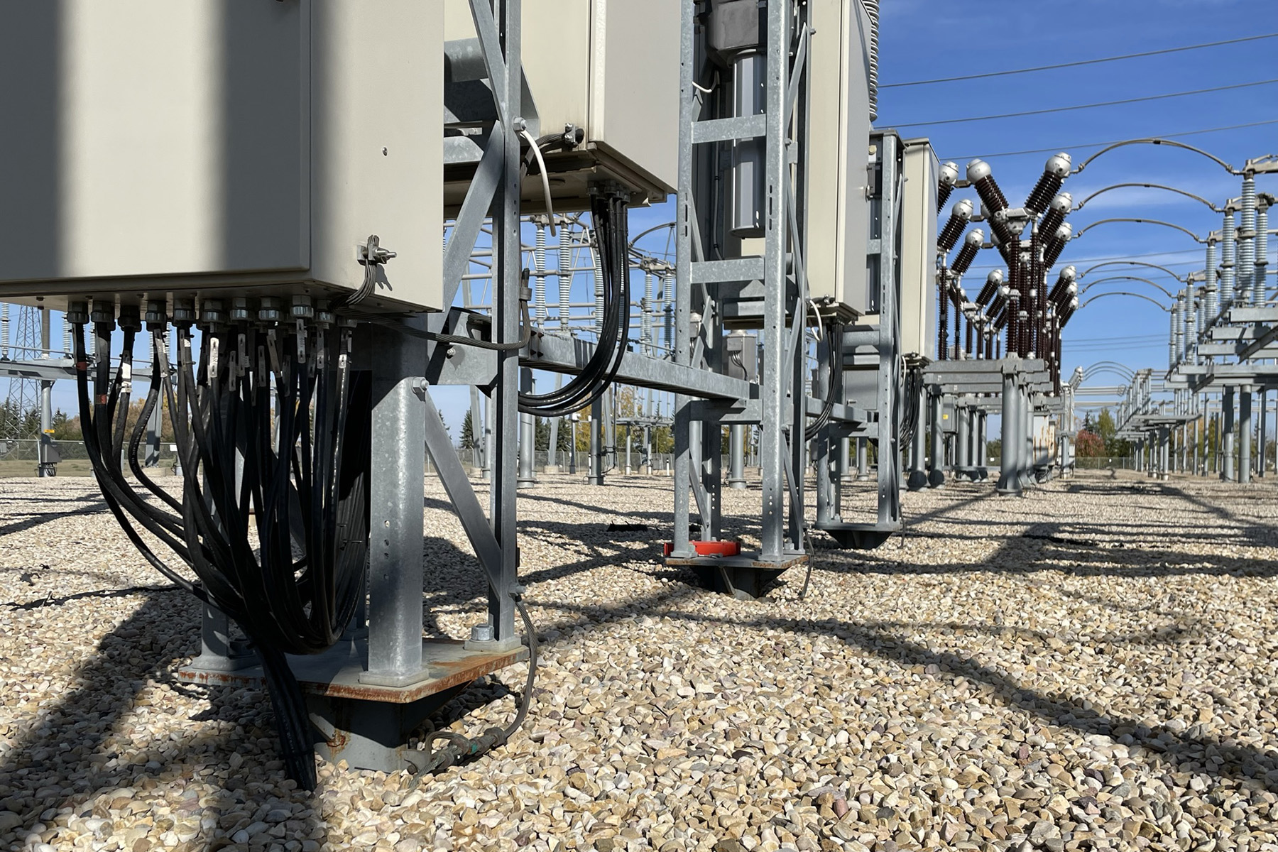 The photo shows the ground beneath different electrical equipment at a substation. 