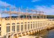 a hydropower dam building beside river with spillway and power equipment