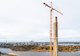 Aerial view of a bridge pylon under construction with crane