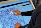 a person operates touchscreen featuring a map